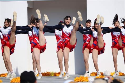 A Group Of Women In Red And White Cheerleaders