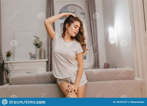 blissful girl posing with pleasure in morning standing in cute cozy room sensual caucasian