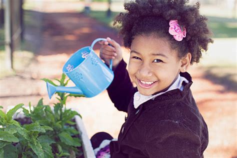 African American Girl Watering Can Stock Photos Pictures And Royalty