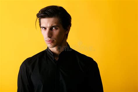 Handsome Of A Serious Young Man In Black Shirt Looking With Attitude