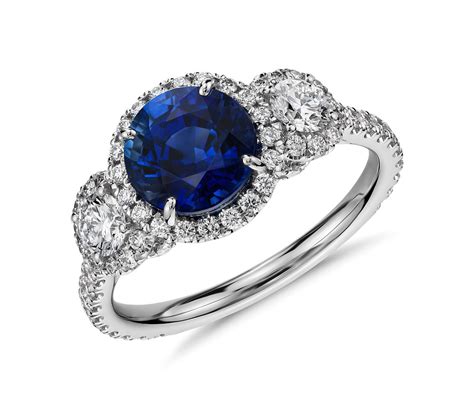 Halo diamond engagement rings are a popular and versatile style for modern brides. Sapphire and Diamond Halo Three-Stone Ring in 18k White Gold (2 ct center) | Blue Nile