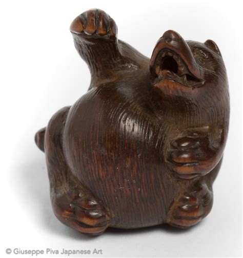 1950sseldom seenhand crafted with fine detailsunused from old stocknetsuke size: Wood netsuke of a tanuki while he is beating his belly ...