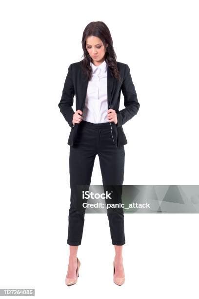Candid Business Woman Getting Dressed Holding Black Unbuttoned Suit