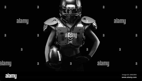 portrait of a girl in the uniform of an american football team player black background sports