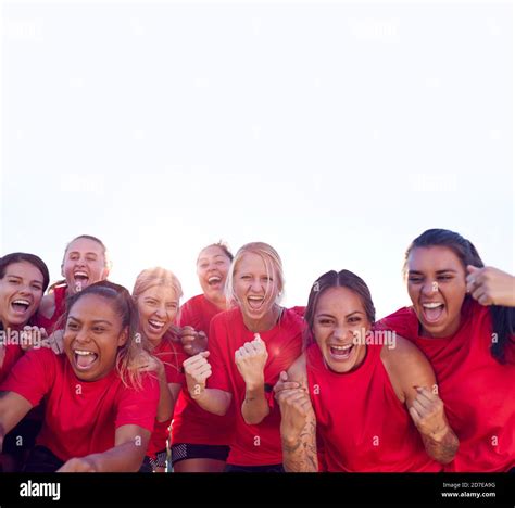 Portrait Of Womens Football Team Celebrating Winning Soccer Match On