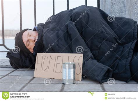 Homeless Man Lying On Cold Pavement Stock Photo Image Of Help