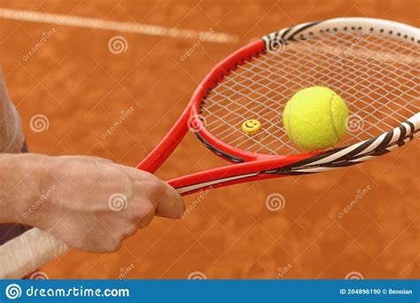 Male Player Holding Tennis Ball And Racket On Tennis Court Stock Photo