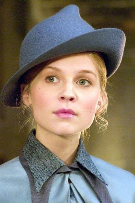 A Woman Wearing A Blue Hat And Tie
