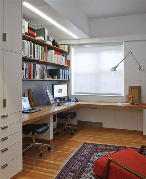 A Home Office With Desk Computer And Bookshelf