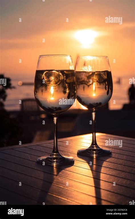 Two Glasses And Sunset In The Beach Stock Photo Alamy