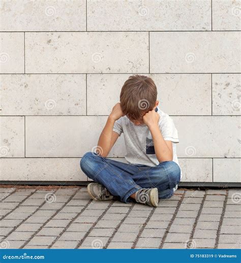 Sad Lonely Unhappy Disappointed Child Sitting Alone On The Ground