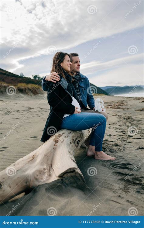 Pregnant On The Beach With Her Partner Stock Photo Image Of Looking Husband