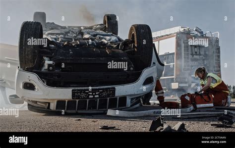 Rescue Team Of Firefighters And Paramedics Work On A Terrible Car Crash