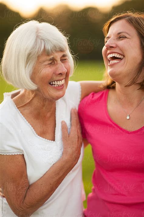 senior mother and mature daughter laughing together by stocksy contributor lee avison stocksy