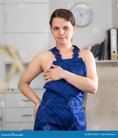 Waist Up Portrait Of Seductive Naked Woman In Overall In Office Stock