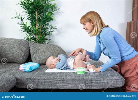 Young Mother Changing The Diapers Of Her Baby Stock Image Image Of