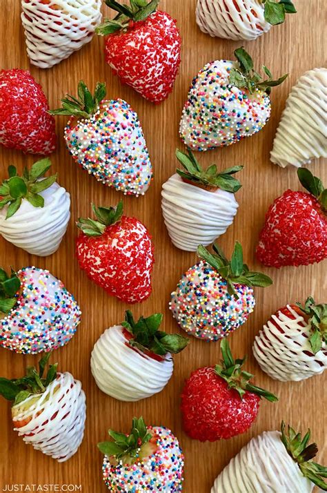 A Top Down View Of Homemade White Chocolate Covered Strawberries Including Some Decorated With