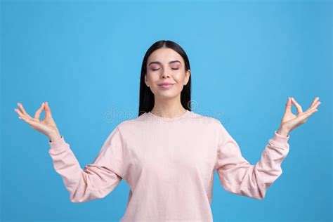 Young Woman Meditating On Light Blue Background Stress Relief Exercise