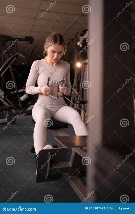 Caucasian Muscular Woman Performs Traction Exercise On The Waist And