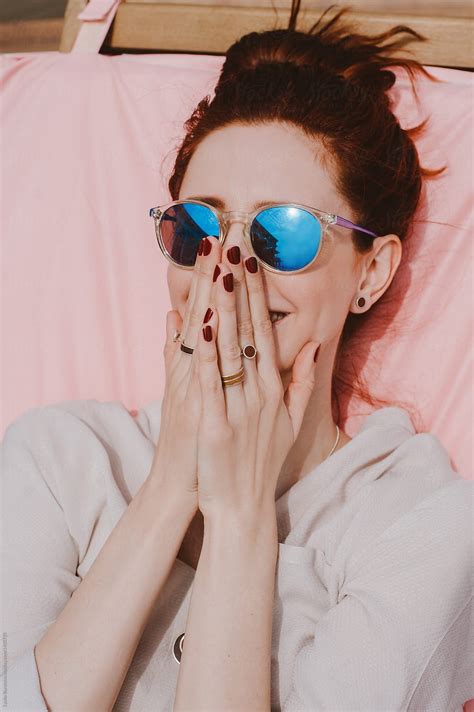 happy woman wearing bright blue sunglasses by stocksy contributor amor burakova blue