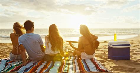 Group Of Friends Having Fun Relaxing On The Beach At Sunset Stock Footage Video