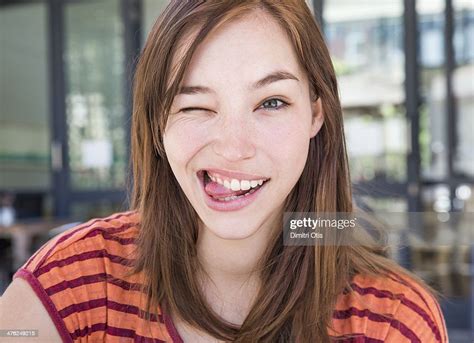 Young Woman Winking With Her Tongue Out Photo Getty Images