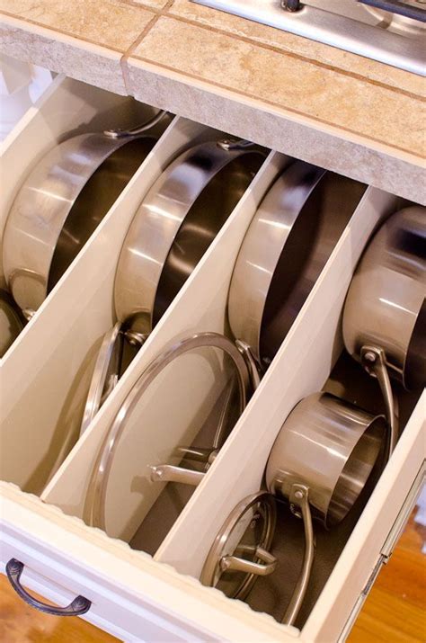 An Open Drawer Filled With Pots And Pans