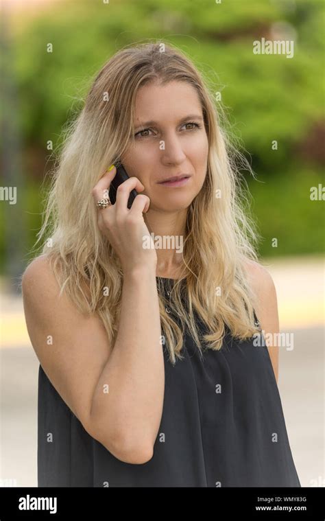 Worried Woman Receiving Bad News Over The Phone Stock Photo Alamy