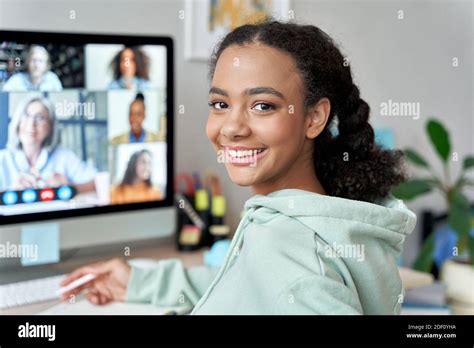 Teen Mixed Race Girl School Student Learning Online At Home Looking At