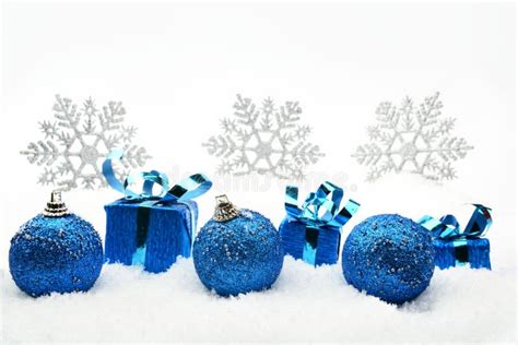 Blue Christmas Ts And Baubles With Snowflakes On Snow Stock Image