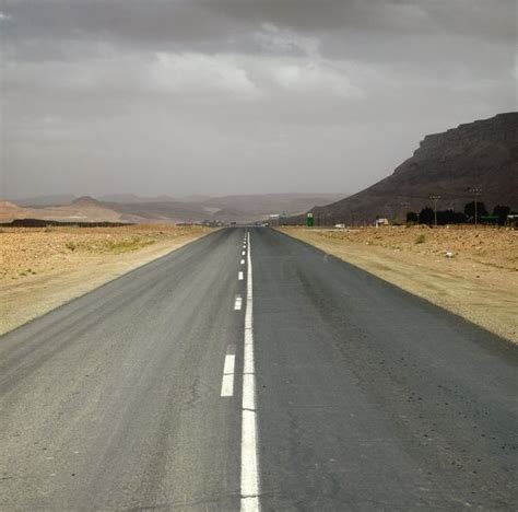 Print Of Dual Tar Road Going Through Arid Area On An Overcast Day In
