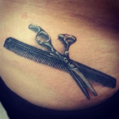 Black Realistic Scissor And Comb Tattoo On Lower Back