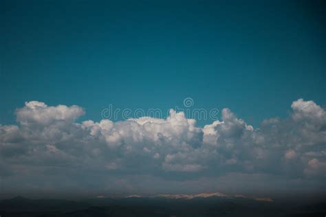 Turquoise Blue Sky With Clouds Over Mountain Tops Stock Photo Image