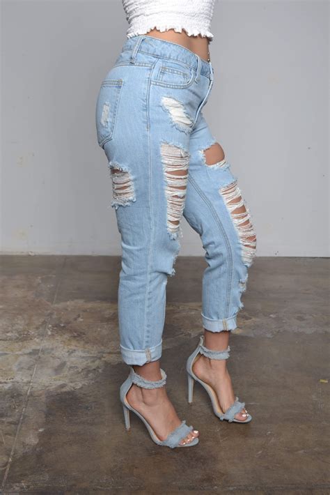 Light Blue Heavily Distressed Jeans In Front And Back With Sewn Hem And
