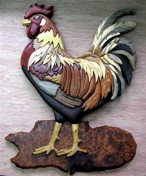 A Metal Rooster Sitting On Top Of A Piece Of Wood Next To A Wooden Board