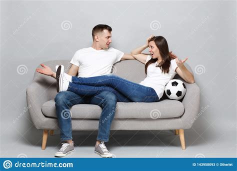 nervous couple woman man football fans cheer up support favorite team with soccer ball spreading