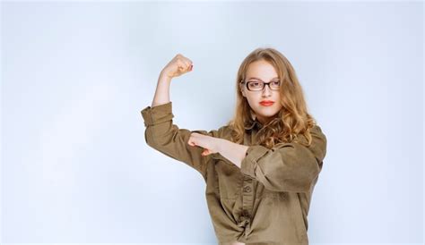 free photo blonde girl showing her fist and feeling powerful