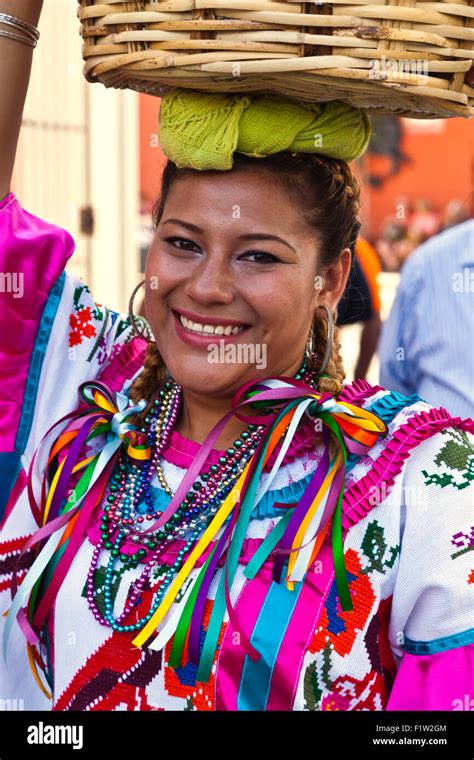 A Traditionally Dressed Mexican Woman In A Parade During The July