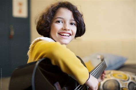 Little Girl Playing Guitar By Irina Ozhigova