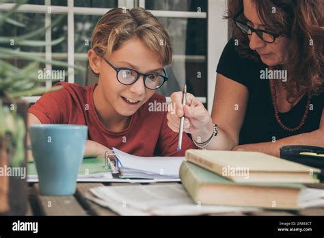 Astonished Student Doing Homework At Home With School Books Newspaper