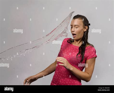 Young Woman Being Splashed With Water Hi Res Stock Photography And