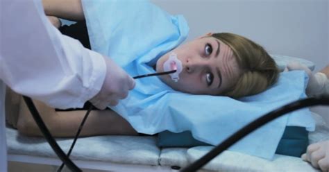 Doctor Makes An Endoscopy Through The Mouth Of A Young Girl