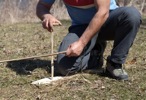 Man Using Sticks And Friction Method To Start A Fire Stock Photo
