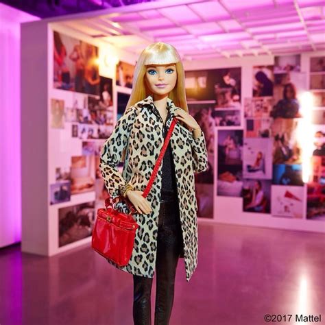 A Barbie Doll Is Dressed In Leopard Print And Carrying A Red Handbag