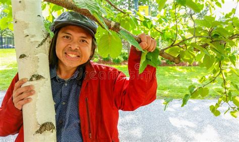 Smiling Asian Man Holding Branch Of A Birch Tree Stock Image Image Of