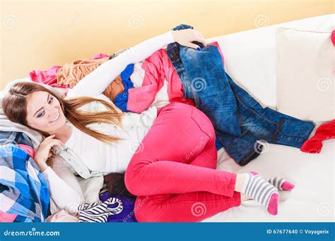 Happy Woman Lying On Sofa In Messy Room At Home Stock Photo Image Of