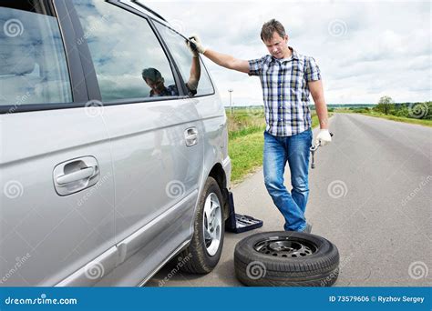 Man Changing A Spare Tire Of Car Stock Photo Image Of Landscape Crash