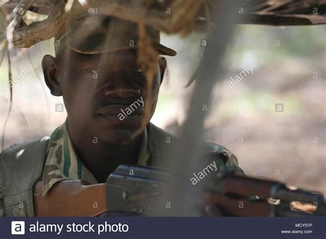 A Zambian Soldier Prepares To Engage A Target From A Concealed Position