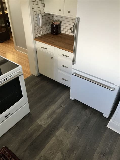 When installing laminate flooring in kitchens and bathrooms, you cannot place cabinets or any hardware that is meant to be bolted permanently to the floor on the laminate. Farmhouse Fabulous: New Flooring for the Kitchen - This American House