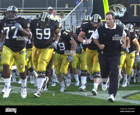 University Of Missouris Head Football Coach Gary Pinkel Right Is Shown As He Leads The